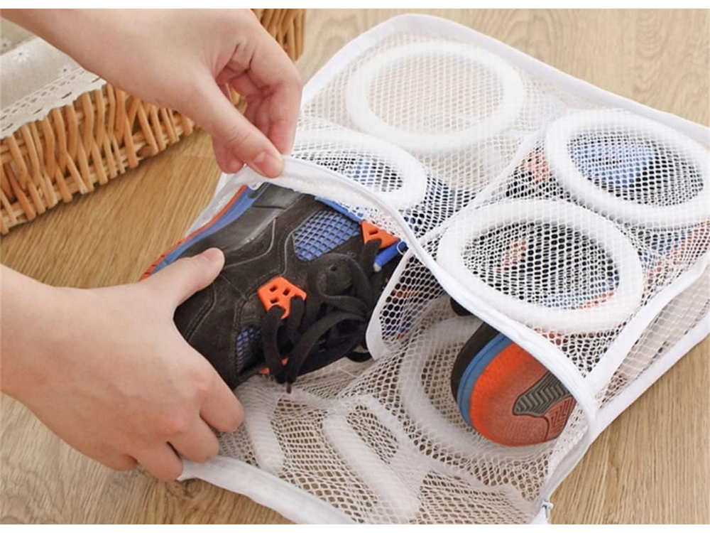 Tennis shoes placed in a mesh laundry bag before washing